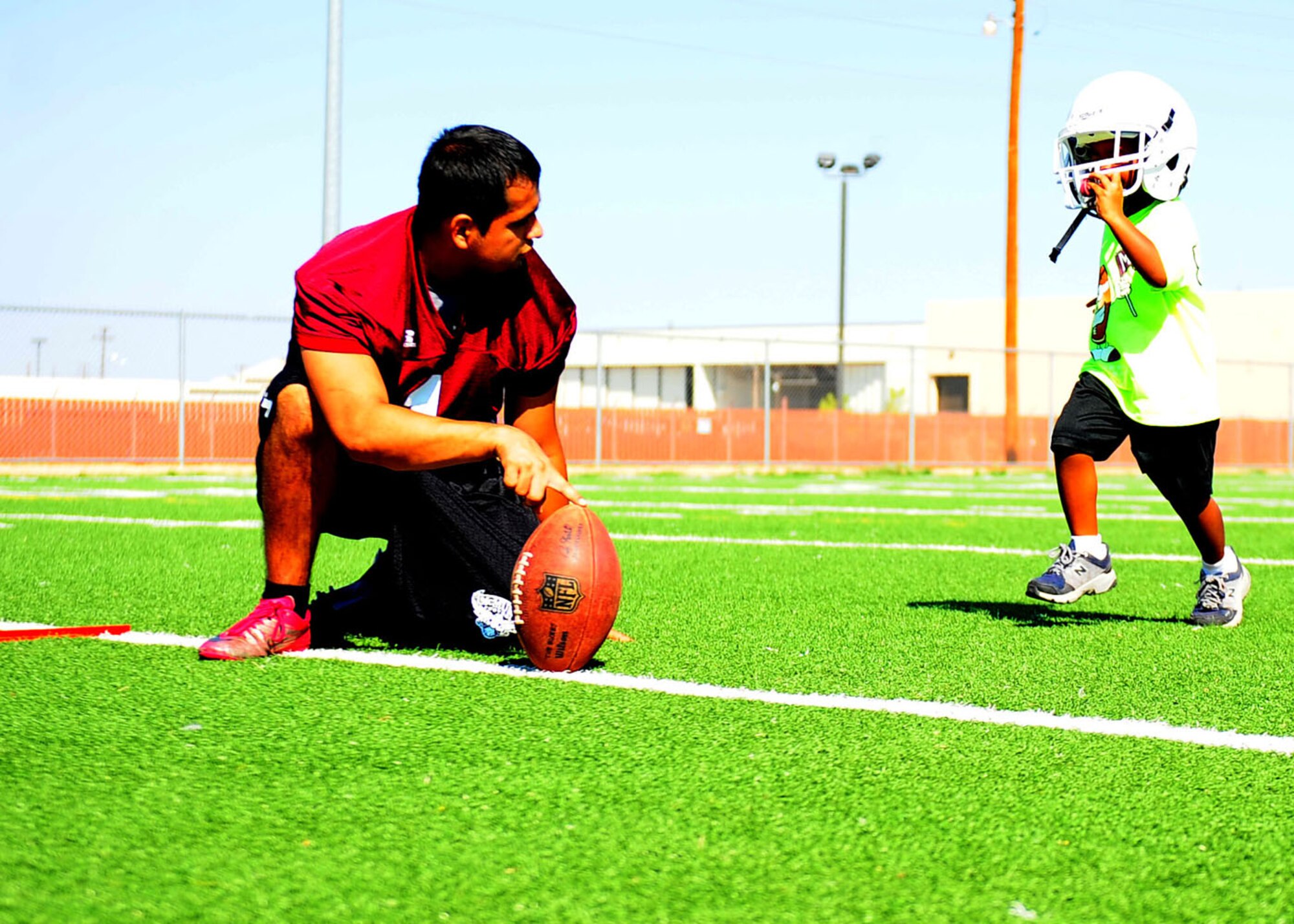 Josiah Williams, son of Lt. Col. Trevor Williams, 7th Comptroller Squadron commander, attempts a 30-yard field goal Aug. 27 at Dyess Air Force Base, Texas, during Bleacher Creature camp. The camp was for children from the age of five through fifth grade. During the camp they had the opportunity to run drills, learn plays and meet the players. (U.S. Air Force photo by Senior Airman Chelsea Browning/Released)