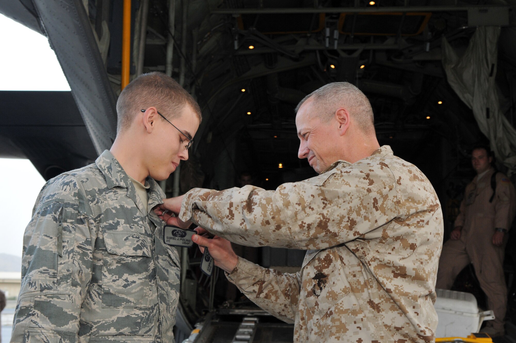 Marine Corps Gen. John R. Allen, commander of NATO and International Security Assistance Force troops in Afghanistan, promoted Airman 1st Class Gabriel J. Poling, a cyber transport systems Airman deployed from 325th Communications Squadron, Tyndall Air Force Base, Fla., Aug. 25 to the rank of senior airman. The impromptu promotion ceremony took place on the flightline of Kabul International Airport following a battlefield circulation of Regional Command-Southwest. Airman Poling is part of COMISAF's joint communications team who help keep General Allen connected to military and civilian leaders about all things Afghanistan. ISAF is a key component of the international community's engagement in Afghanistan, assisting Afghan authorities in providing security and stability while creating the conditions for reconstruction development. (Photo by Master Sgt. Michael O'Connor) 