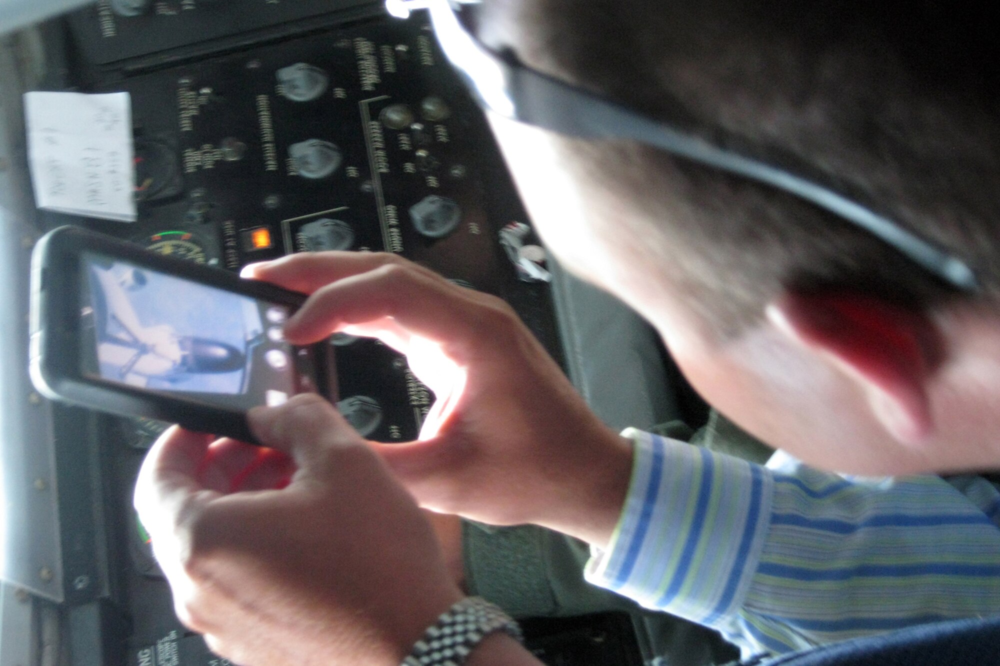 GRISSOM AIR RESERVE BASE, Ind. -- Indiana state Rep. Heath VanNatter takes a photo of an in-flight refueling from the boom pod of a KC-135R Stratotanker Aug. 17. Grissom hosted members of Indiana's state legislature to educate them on the base and the Airmen who perform the mission here. During the mission, the group witnessed an aerial refueling between Grissom's KC-135R and an RC-135 from Offutt Air Force Base, Neb. In all, 21 people participated in the flight. (U.S. Air Force photo/Tech. Sgt. Douglas Hays)