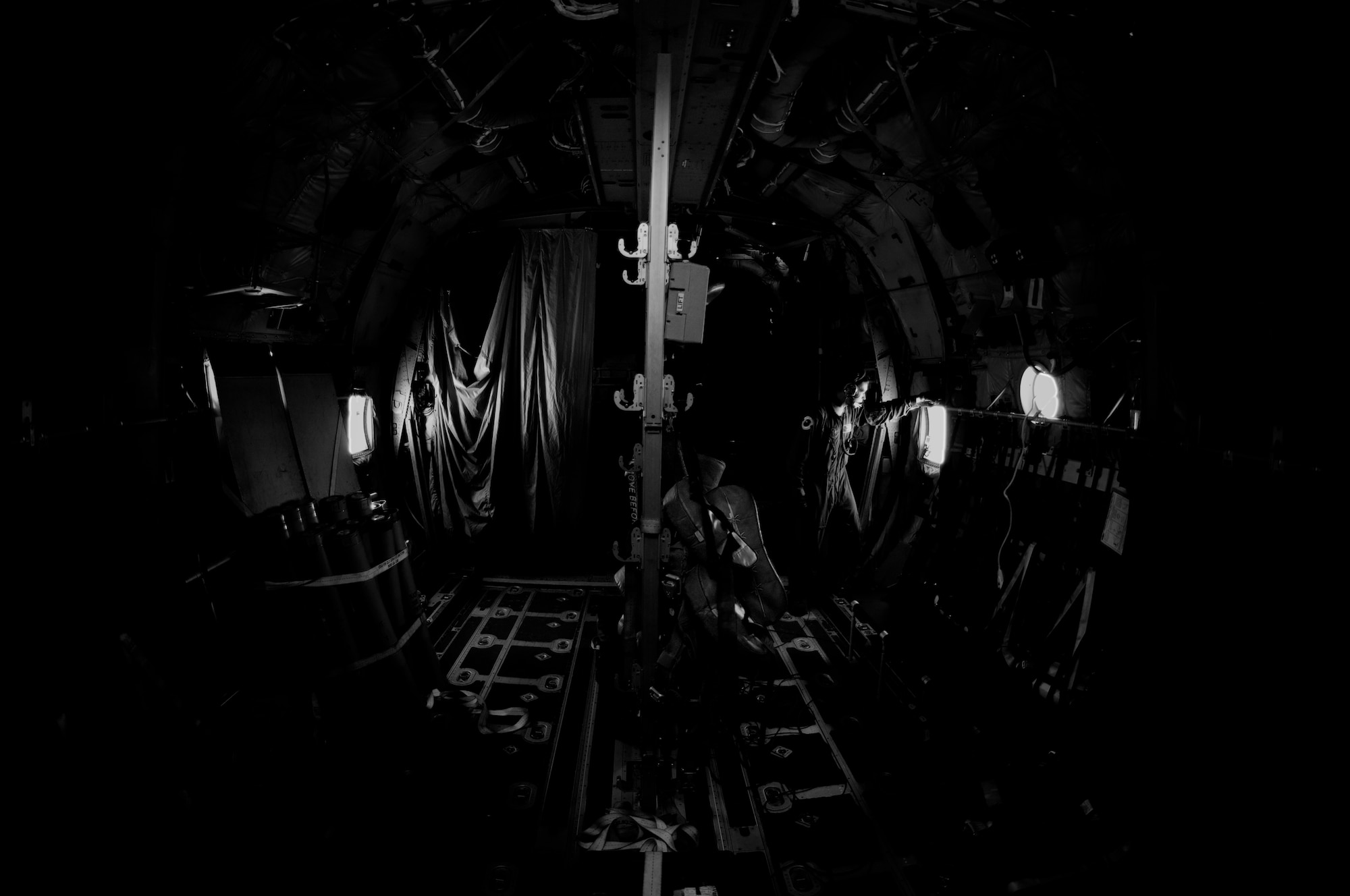 Any Hurricane Hunter will agree that their job entails long hours. In fact, a typical hurricane mission lasts 10-12 hours and involves five end-to-end trips into the eye of the storm in the pursuit of gathering data needed to more accuractly predict its path. Senior Airman Thomas Barnaby, a dropsonde operator with the 53rd Weather Reconnaissance Squadron's Hurricane Hunters, spends a few minutes of down-time on the long ride to Hurricane Irene gazing from the back window of the aircraft. He also carries some of his favorite reads along with him.