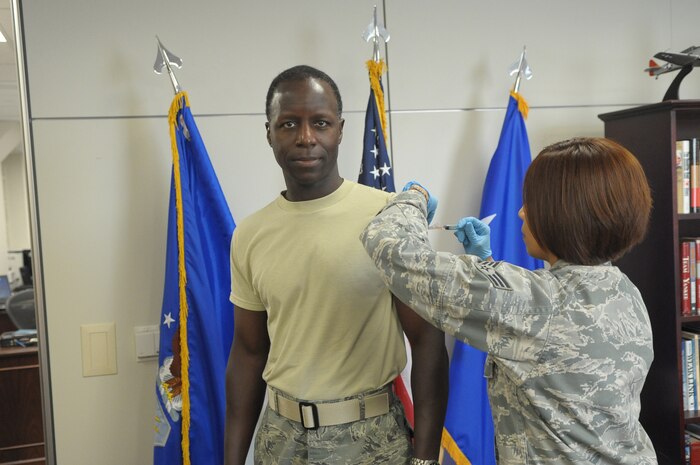 General Edward Rice receives flu shot.