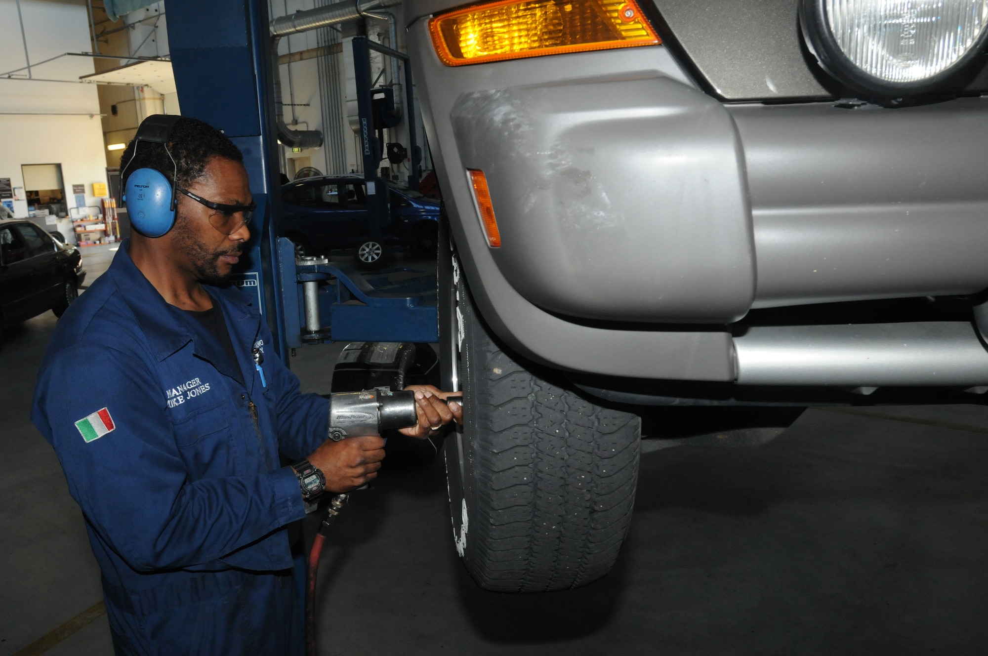 Mike Jones, 31st Force Support Squadron Auto Hobby Shop manager, begins the process of removing a tire from a sport utility vehicle Aug. 18 at Aviano Air Base, Italy. The Auto Hobby provides automotive repairs and diagnosis with lifts, stall spaces, specialized equipment, do-it-yourself workspace and certified staff to assist with all vehicle maintenance needs. (U.S. Air Force photo/Airman LaVel Sterling)