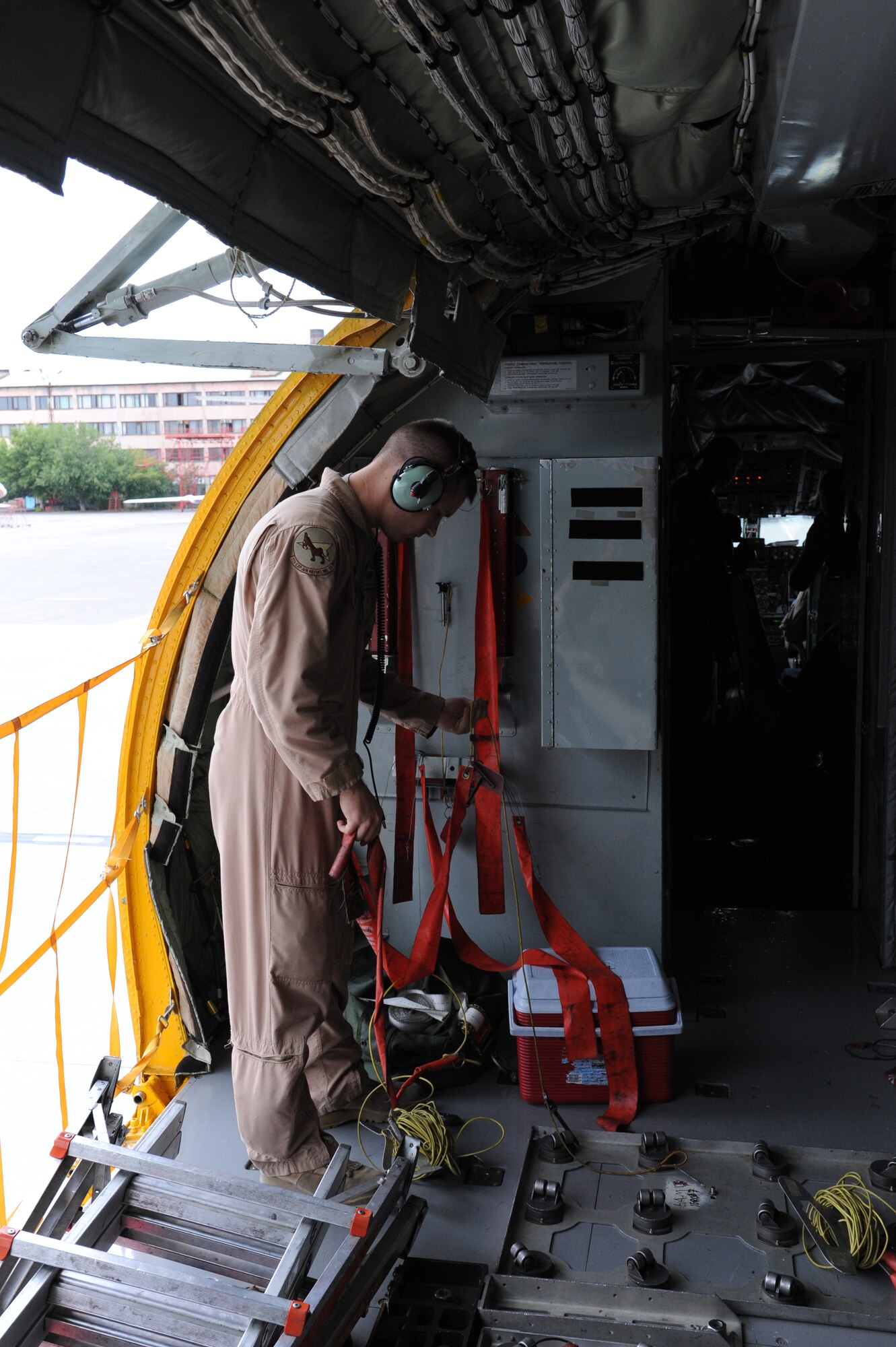 Staff Sgt. Aaron Tessmann stows safety gear as part of his pre-flight checks on a KC-135 Stratotanker stationed at the Transit Center at Manas, Kyrgyzstan, Aug. 27. Tessman is a 22nd Expeditionary Air Refueling Squadron boom operator. He is deployed from the 93rd Air Refueling Squadron at Fairchild Air Force Base, Wash. (U.S. Air Force photo/Tech. Sgt. Hank Hoegen)