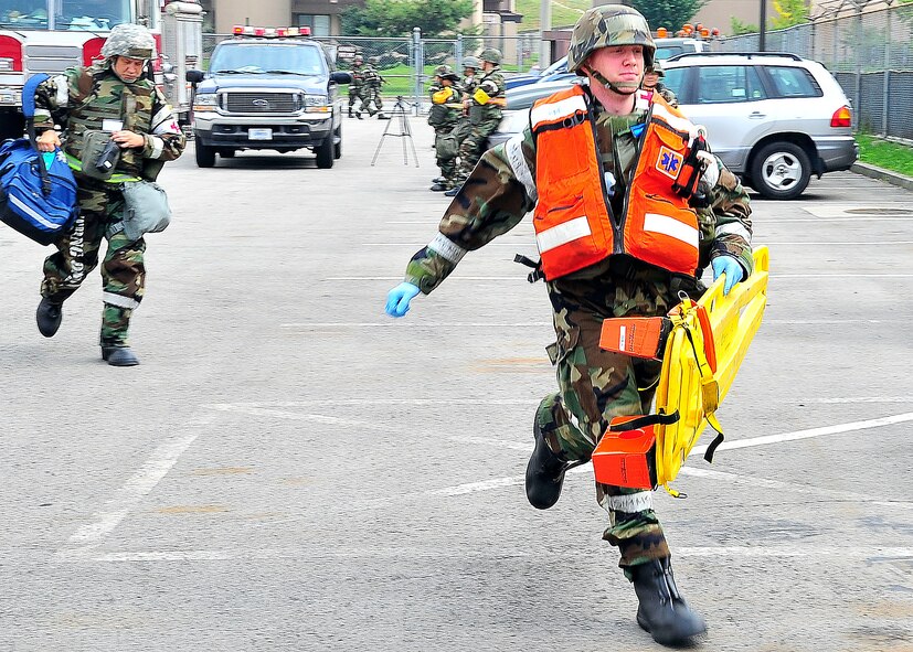 Members from the 51st Medical Group, rush to respond to injured patients during a mass causality collection Aug. 30, 2011, during exercise Beverly-Midnight 11-04. Exercises, such as this, sharpen Osan's ability to survive and operate during combat. All exercises are monitored by subject-matter experts to observe how quickly, safely and properly “players” respond.  (U.S. Air Force photo/Senior Airman Adam Grant)  