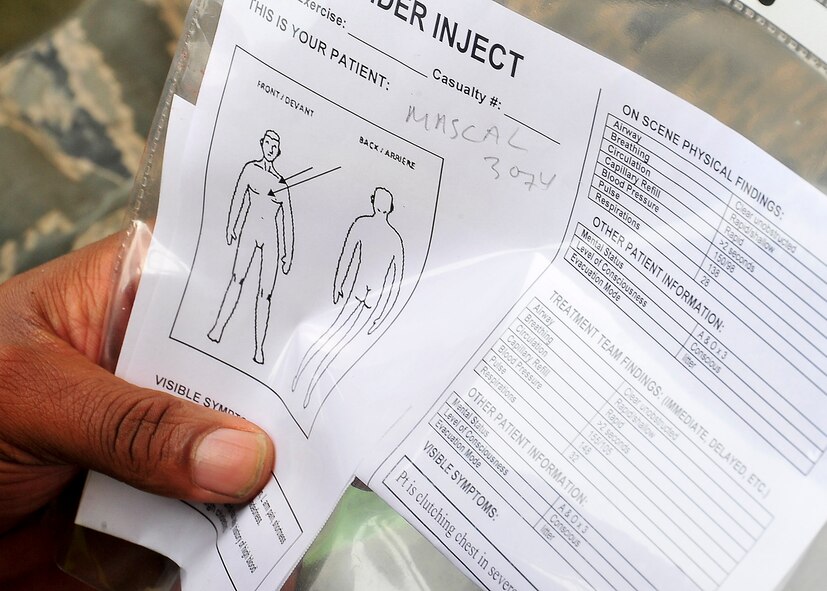 A member of the casualty collection team reads the inject card assigned to a patient to better assess any injuries Aug. 30, 2011, during exercise Beverly-Midnight 11-04. Exercises, such as this, sharpen Osan's ability to survive and operate during combat. (U.S. Air Force photo/Senior Airman Adam Grant)  