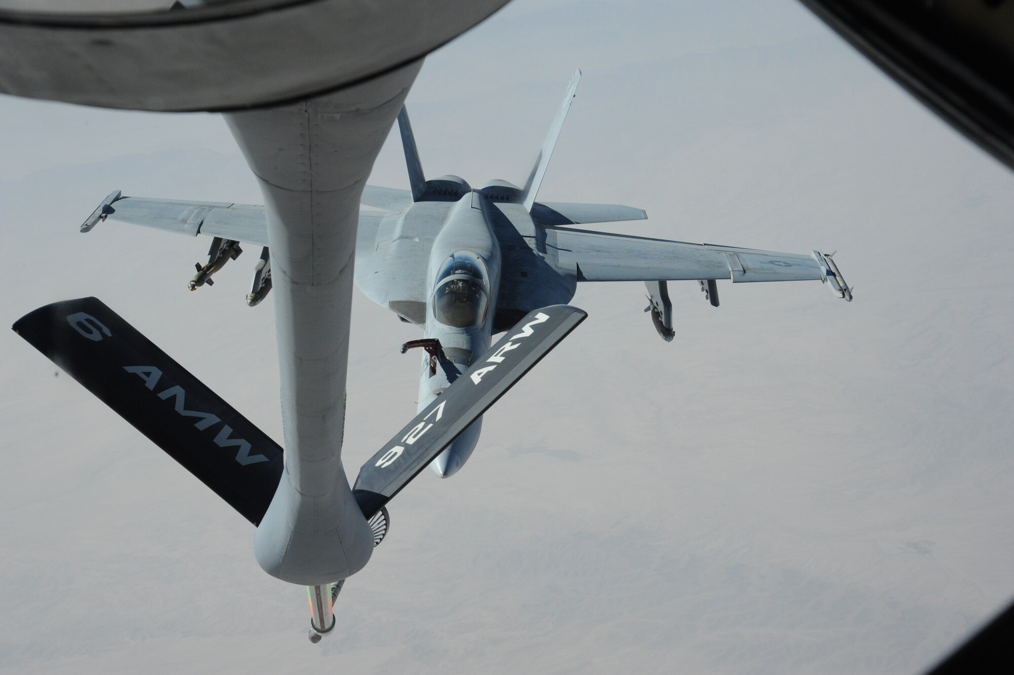 An FA-18 Super Hornet assigned to the USS George H.W. Bush, approaches the fuel boom of a KC-135 Stratotanker over Afghanistan Aug. 27. The KC-135 Stratotanker is assigned to the 22nd Expeditionary Air Refueling Squadron at the Transit Center at Manas, Kyrgyzstan. (U.S. Air Force photo/Tech. Sgt. Hank Hoegen)