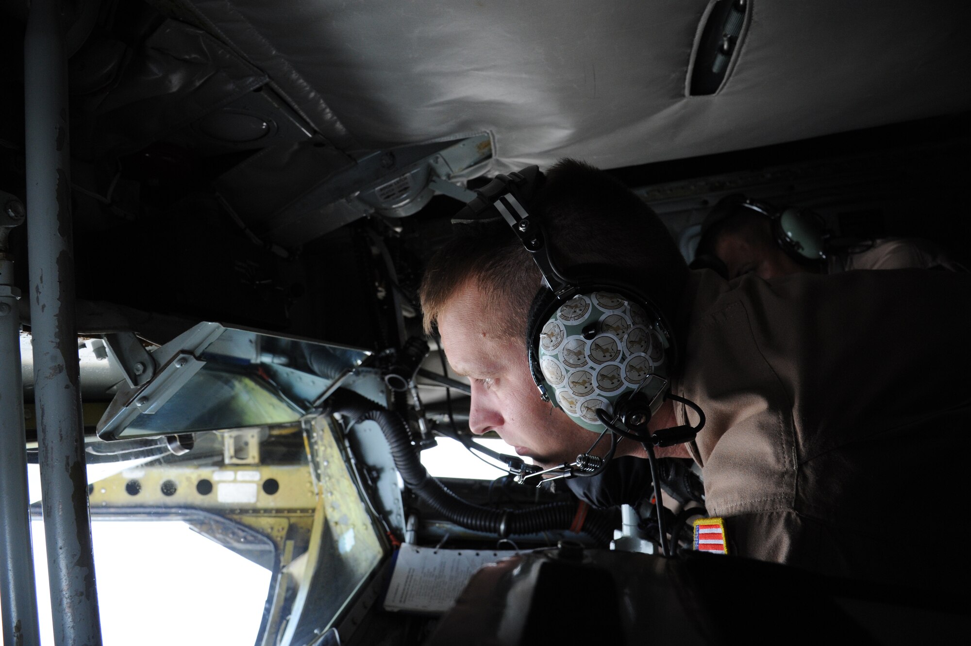 Staff Sgt. Aaron Tessmann, 22nd Expeditionary Air Refueling Squadron boom operator, looks out the boom window for approaching aircraft as he flies over Afghanistan Aug. 27. Tessman is deployed to the Transit Center at Manas, Kyrgyzstan, from the 93rd Air Refueling Squadron at Fairchild Air Force Base, Wash. (U.S. Air Force photo/Tech. Sgt. Hank Hoegen)