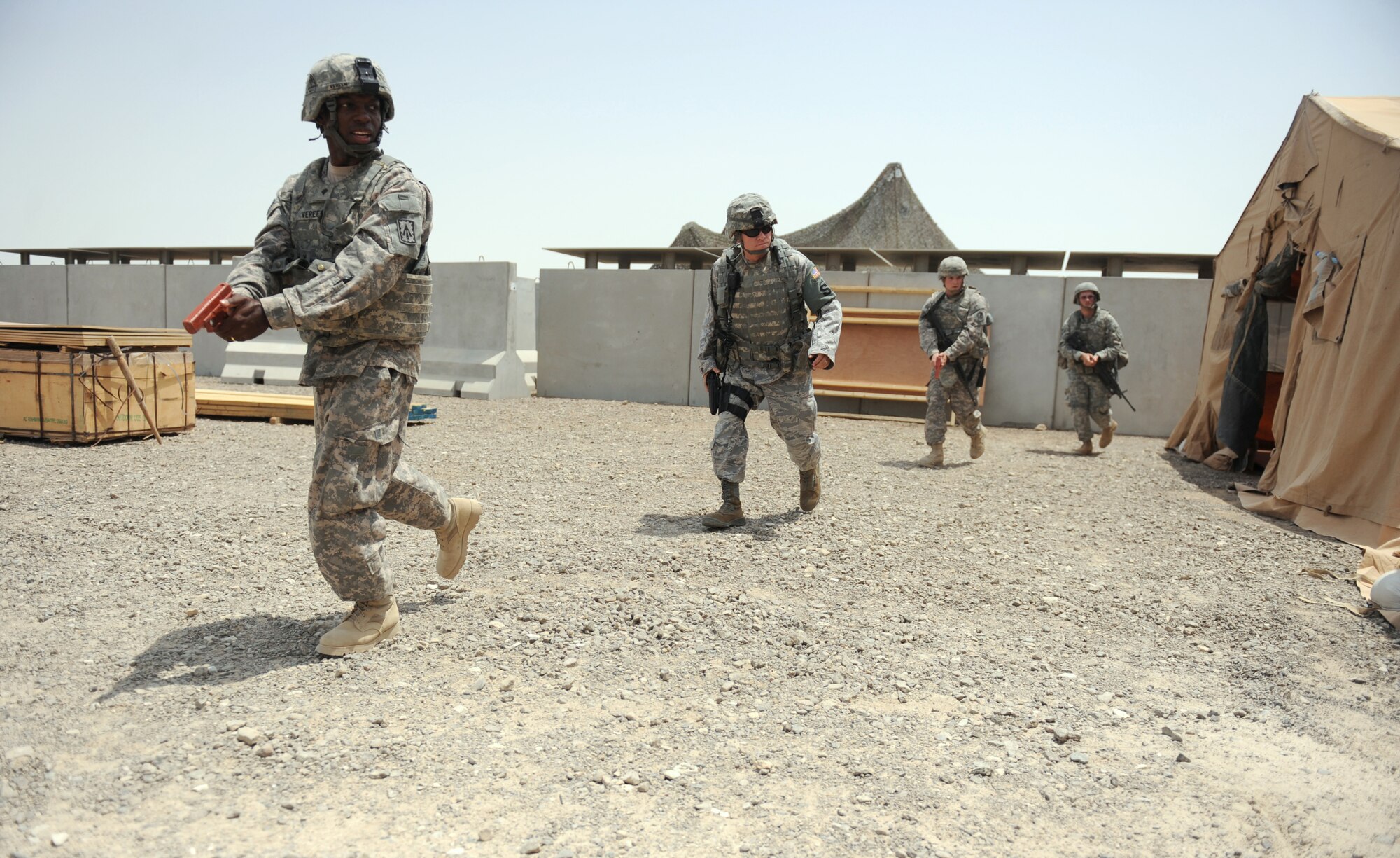 Airmen from the 380th Expeditionary Security Forces Squadron and quick reaction force members from the U.S. Army's 3rd Battalion, 4th Air Defense Artillery Regiment react to a simulated active shooter during an exercise on the Army's Patriot missile site Aug. 24, 2011, at an air base in Southwest Asia. The exercise was the first of several unit-level active shooter exercises to be conducted by the 380th ESFS. (U.S. Air Force photo/Master Sgt. Chance Babin)