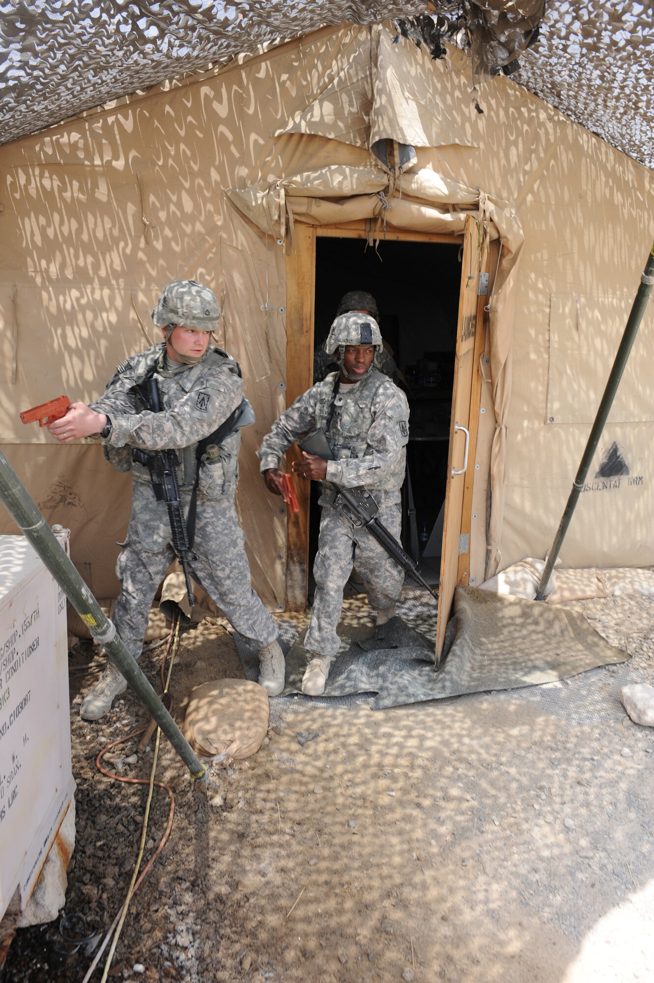 Members of the Army's quick reaction force from 3rd Battalion, 4th Air Defense Artillery Regiment conduct building sweeps during a simulated active shooter exercise on the Army's Patriot missile site Aug. 24, 2011, at an air base in Southwest Asia. The exercise was the first of several unit-level active shooter exercises to be conducted by the 380th Expeditionary Security Forces Squadron. (U.S. Air Force photo/Master Sgt. Chance Babin)