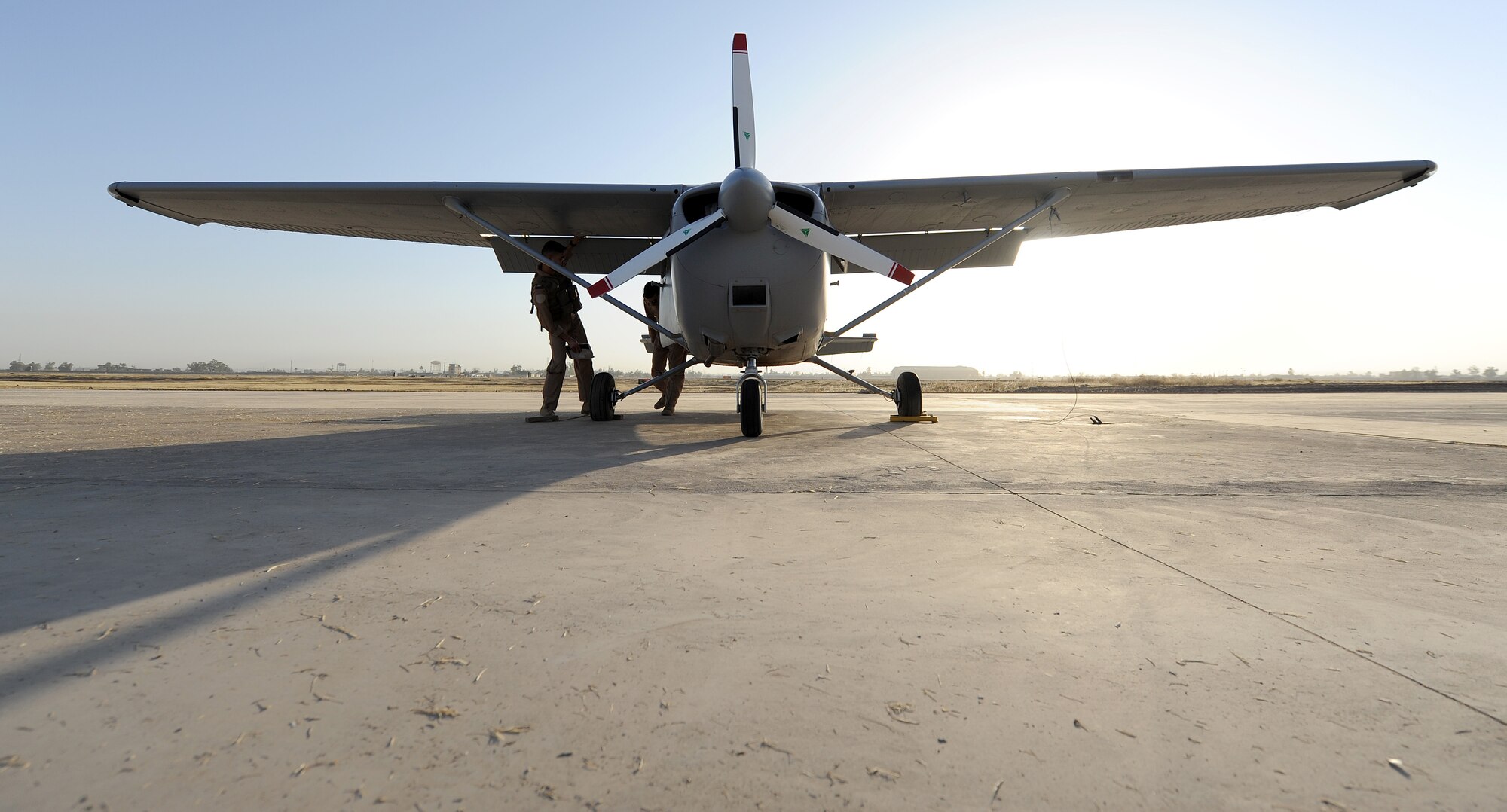 An Iraqi pilot checks over the plane at Kirkuk Air Base. He is checking the plane for unwanted cracks that could cause trouble during the flight. (U.S. Air Force photo/Senior Airman Tristin English)


