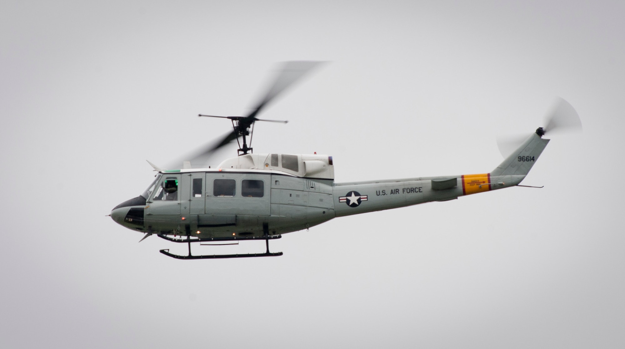 YOKOTA AIR BASE, Japan -- A UH-1N Iroquois helicopter flies over the flightline at Yokota Air Base, Japan, during the Japanese-American Friendship Festival Aug. 20, 2011. The "huey" was only able to fly on the first day of the two-day festival due to inclement weather. (U.S. Air Force photo/Staff Sgt. Samuel Morse)