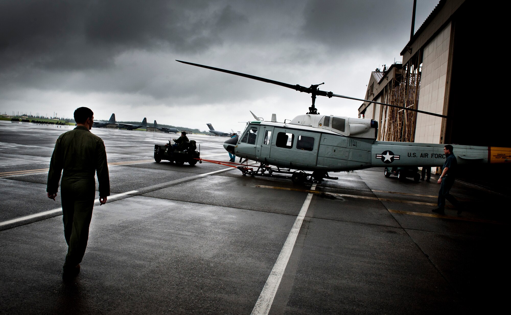YOKOTA AIR BASE, Japan -- Capt. Nicholas Ringo, 459th Airlift Squadron co-pilot, monitors the towing of a UH-1N Iroquois onto the flightline at Yokota Air Base, Japan, Aug. 21, 2011. (U.S. Air Force photo/Staff Sgt. Samuel Morse)
