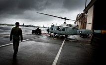YOKOTA AIR BASE, Japan -- Capt. Nicholas Ringo, 459th Airlift Squadron co-pilot, monitors the towing of a UH-1N Iroquois onto the flightline at Yokota Air Base, Japan, Aug. 21, 2011. (U.S. Air Force photo/Staff Sgt. Samuel Morse)