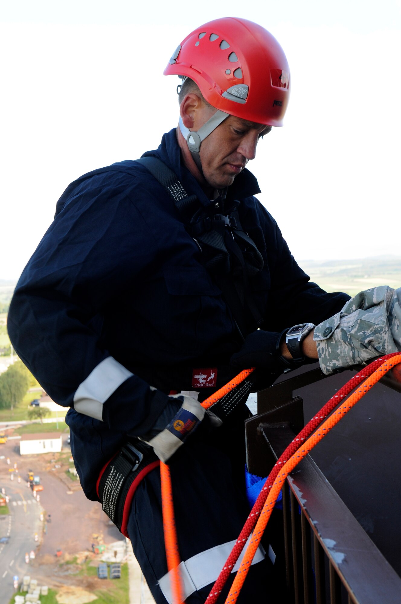 SPANGDAHLEM AIR BASE, Germany -- Gerd Mueller, 52nd Civil Engineer Squadron Fire Department crew chief, rappels from the control tower during a training exercise here Aug. 29. The 52nd CES fire fighters train to rappel so they can be proficient in high-angle rescue techniques. (U.S. Air Force photo/ Airman 1st Class Brittney Frees)