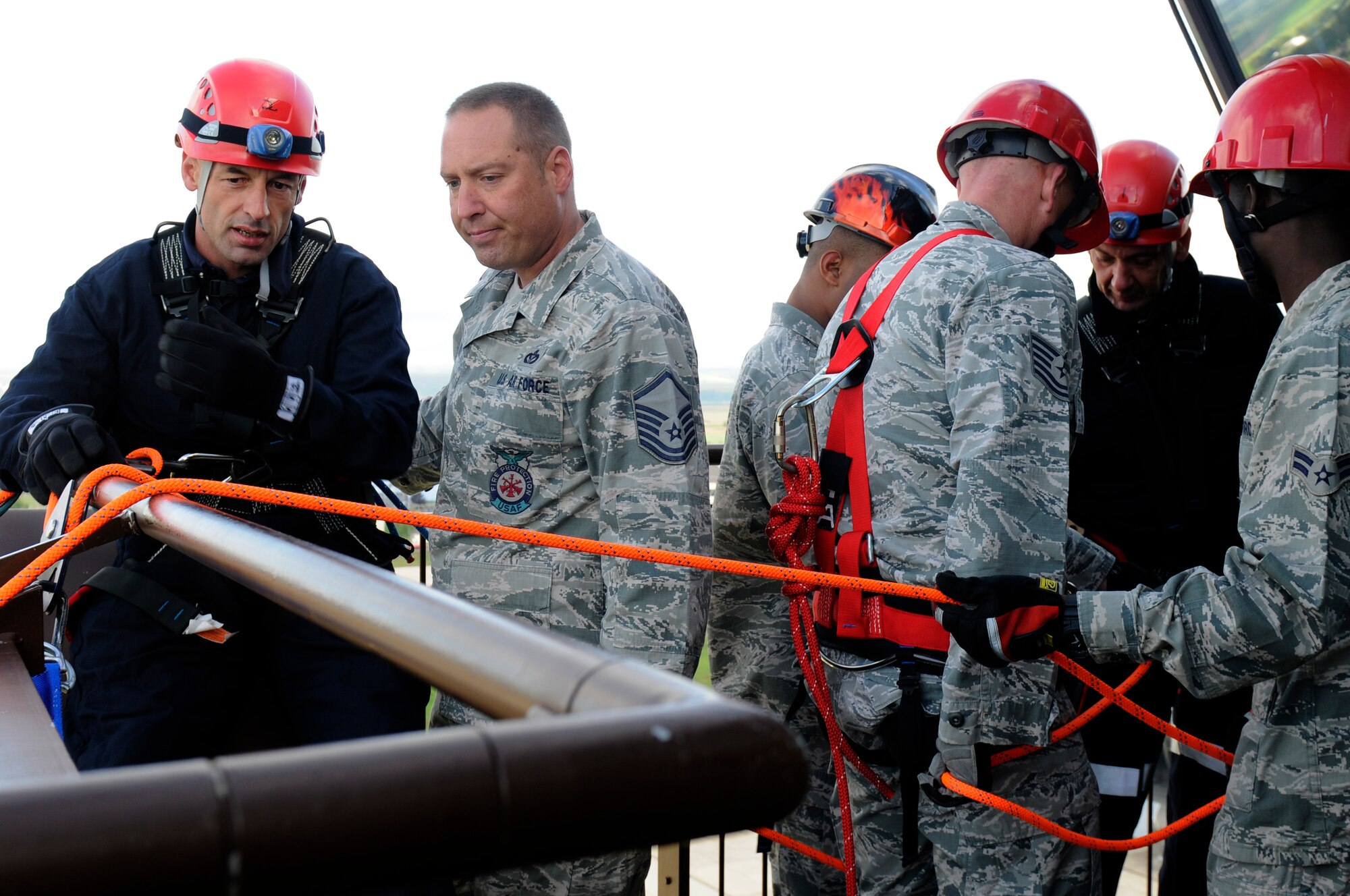 SAPNGDAHLEM AIR BASE, Germany -- Gerd Mueller, 52nd Civil Engineer Squadron Fire Department crew chief, talks with Master Sgt. David Doerr, 52nd CES Fire Department assistant chief, about rappelling from the control tower during a training exercise here Aug. 29. The 52nd CES fire fighters train to rappel so they can be proficient in high-angle rescue techniques. (U.S. Air Force photo/ Airman 1st Class Brittney Frees)