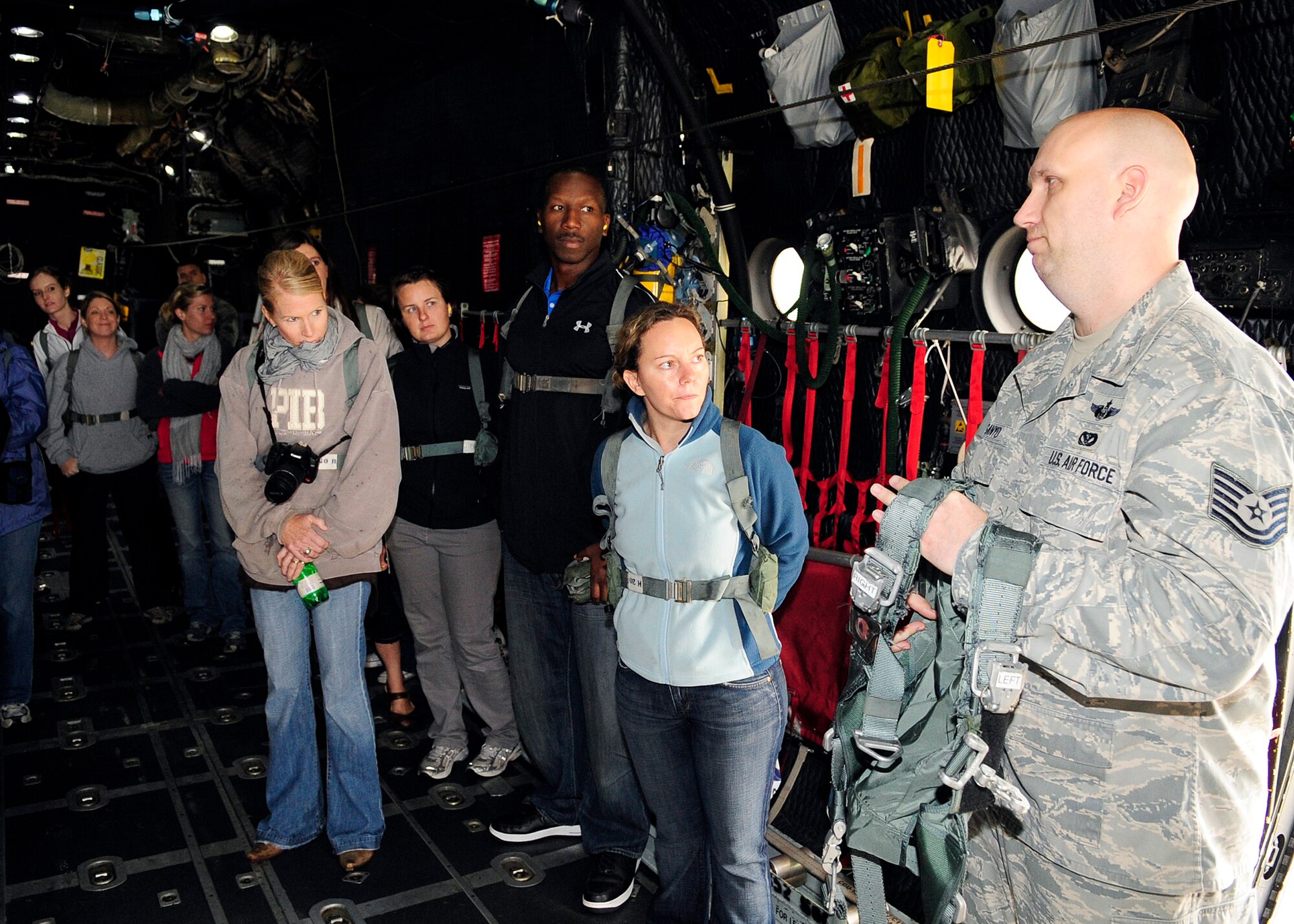 RAF MILDENHALL, England -- Tech. Sgt. John Ganyo, 7th Special Operations Squadron MC-130H Combat Talon II loadmaster, gives an emergency evacuation brief during the 352nd Special Operations Group Spouses’ Day here Aug. 27. 2011. 352nd SOG spouses got to take a closer look at some of the aircraft used to accomplish the mission during the event.  (U.S. Air Force photo by Senior Airman Ethan Morgan)
