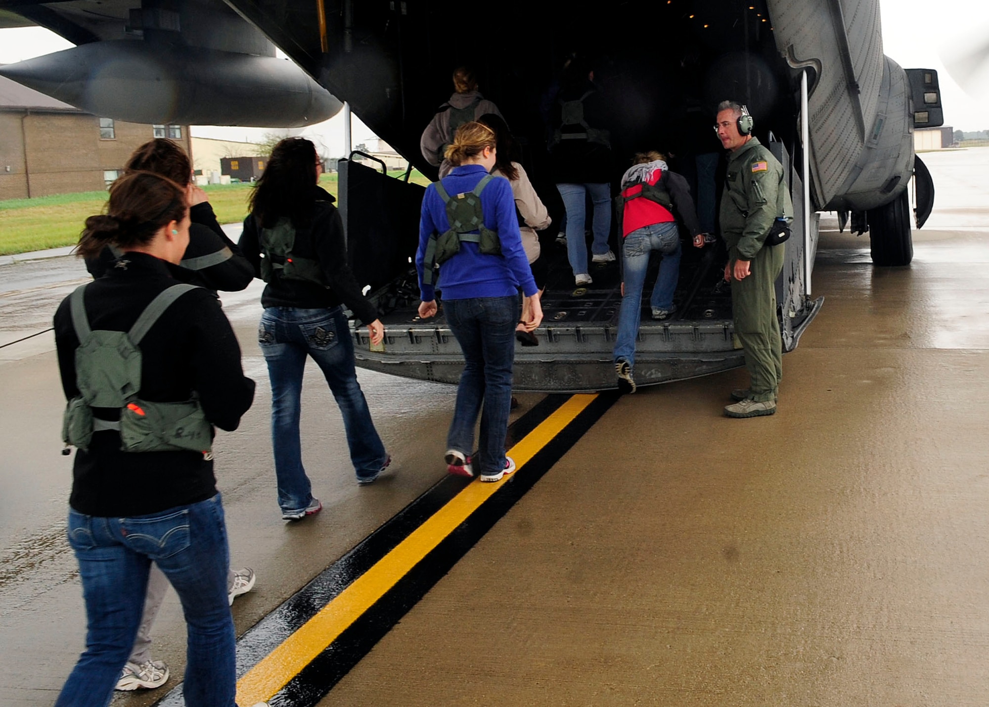 RAF MILDENHALL, England -- Spouses of Airmen with the 352nd Special Operations Group board an MC-130H Combat Talon II during the 352nd Special Operations Group Spouses’ Day here Aug. 27. 2011.  The event helped familiarize 352nd SOG spouses with some of the equipment the group uses daily.  (U.S. Air Force photo by Senior Airman Ethan Morgan)