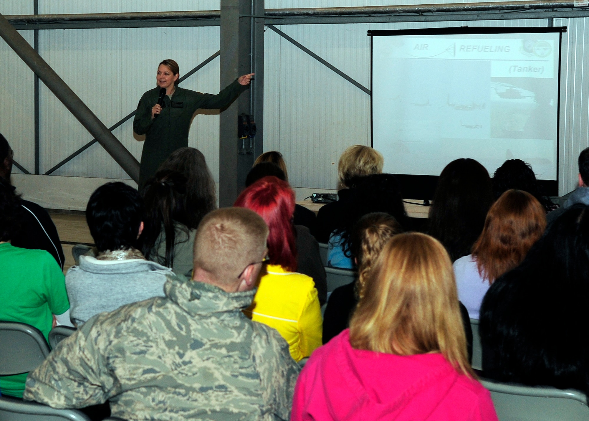 RAF MILDENHALL, England -- Lt. Col. Shelley Rodriguez, 67th Special Operations Squadron commander, gives a mission brief during the 352nd Special Operations Group Spouses’ Day here Aug. 27, 2011.  The event gave 352nd SOG spouses the opportunity to see what their significant others do on a day-to-day basis.  (U.S. Air Force photo by Senior Airman Ethan Morgan)
