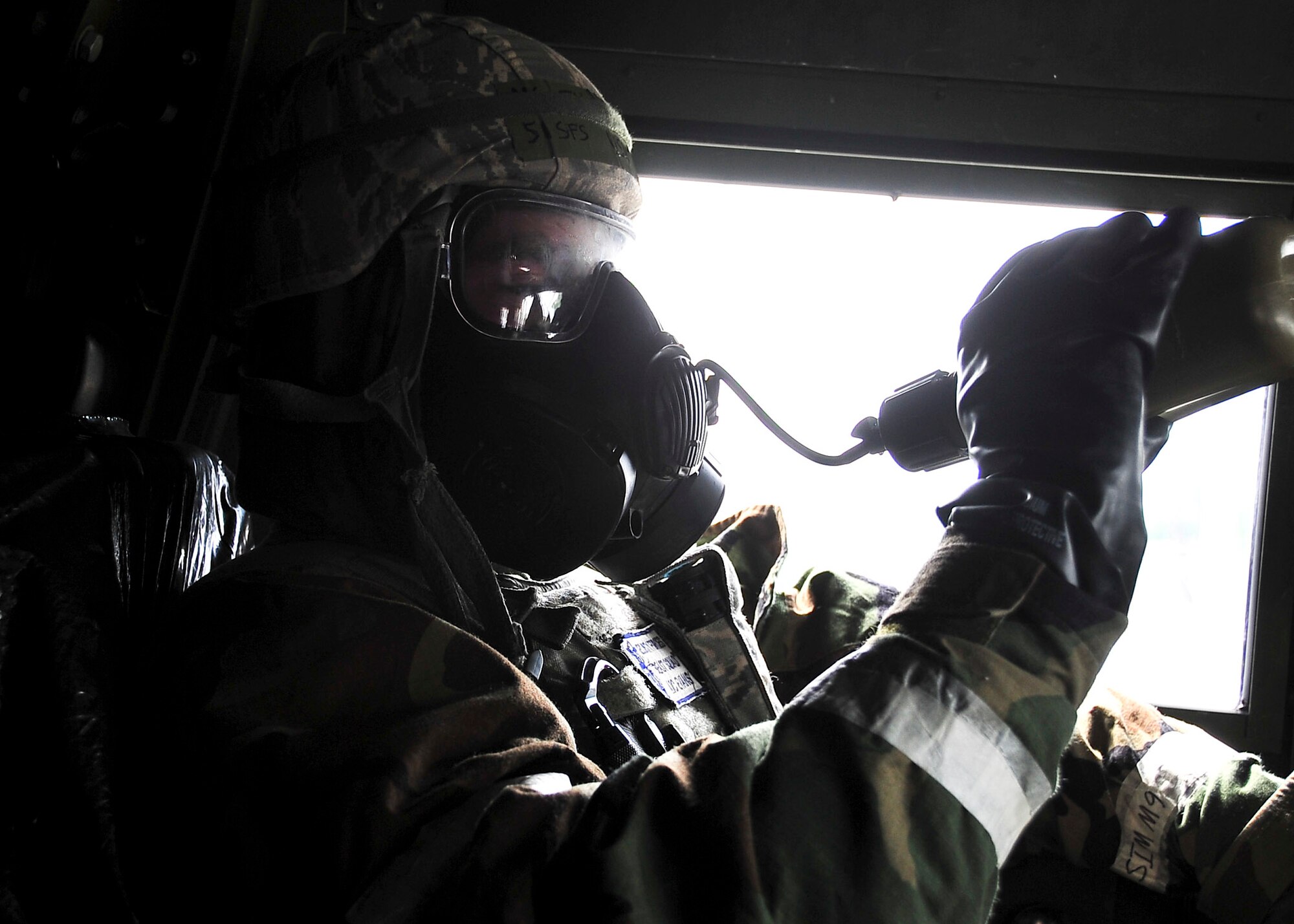 A member of the 51st Security Forces Squadron hydrates through his M50 Joint Service General Purpose Mask during Alarm Black MOPP Level 4 Aug. 30, 2011, during exercise Beverly-Midnight 11-04. Exercises, such as this, sharpen Osan's ability to survive and operate during combat. (U.S. Air Force photo/Senior Airman Adam Grant)   