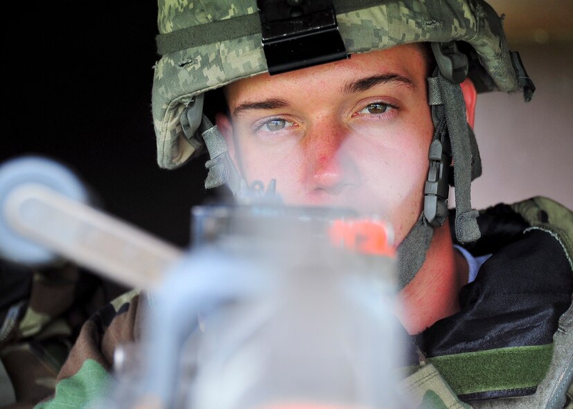 Senior Airman Max Haurer, 51st Security Forces Squadron, scans his field of fire over the top of  an M240B machine gun on hill 180 Aug. 30, 2011, during exercise Beverly-Midnight 11-04. Exercises, such as this, test Osan's ability to survive and operate during combat. (U.S. Air Force photo/Senior Airman Adam Grant)  