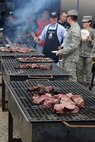 KUNSAN AIR BASE, Republic of Korea -- Airmen stand in line to get their free steak dinner provided by Steak Team Mission here Aug. 25. The Steak Team Mission donated more than 1,500 steaks and volunteered to cook the steaks for the Wolf Pack. (U.S. Air Force photo/Senior Airman Brittany Y. Bateman)

