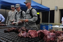 KUNSAN AIR BASE, Republic of Korea -- Airmen stand in line to get their free steak dinner provided by Steak Team Mission here Aug. 25. The Steak Team Mission donated more than 1,500 steaks and volunteered to cook the steaks for the Wolf Pack. (U.S. Air Force photo/Senior Airman Brittany Y. Bateman)

