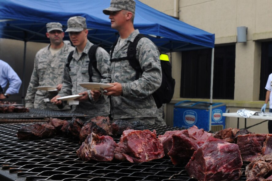 KUNSAN AIR BASE, Republic of Korea -- Airmen stand in line to get their free steak dinner provided by Steak Team Mission here Aug. 25. The Steak Team Mission donated more than 1,500 steaks and volunteered to cook the steaks for the Wolf Pack. (U.S. Air Force photo/Senior Airman Brittany Y. Bateman)

