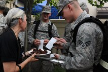 KUNSAN AIR BASE, Republic of Korea -- A volunteer from Steak Team Mission gives out appetizers to Airmen waiting to receive their steak dinner here Aug. 25. Steak Team Mission is a non-profit Dallas-based group that provides food and supplies for military men and women as a gesture of appreciation for their service. (U.S. Air Force photo/Senior Airman Brittany Y. Bateman)

