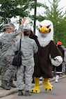 KUNSAN AIR BASE, Republic of Korea -- American Forces Network???s ???The Eagle??? receives high fives from Airmen standing in line to get free steak dinner provided by Steak Team Mission here Aug. 25. The Steak Team Mission donated more than 1,500 steaks and volunteered to cook these steaks for the Wolf Pack.  (U.S. Air Force photo/Senior Airman Brittany Y. Bateman)

