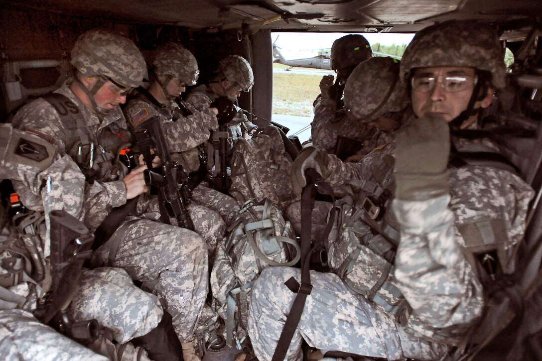 Soldiers wait inside a UH-60A Black Hawk helicopter before taking off for a heliborne insertion mission during the Order of the Arctic Sapper competition on Joint Base Elmendorf-Richardson, Alaska, Aug. 17, 2011.