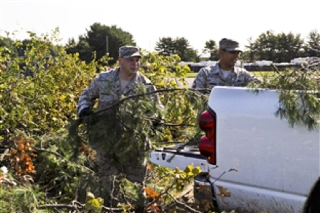 Troops pick up debris at Joint Base McGuire-Dix-Lakehurst, N.J., Aug. 29, 2011, after Hurricane Irene drenched the East Coast. More than eight inches of rain fell and winds exceeded 70 mph in the area. Flooding remains a problem on some roads and parking lots.