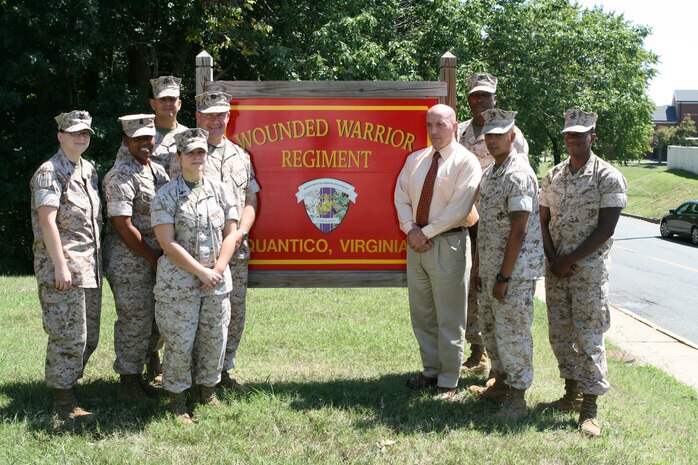 Mark Brokaw, program manager of the Wounded Warrior Regiment’s Reserve Medical Entitlements Determination section, stands outside of the Regiment’s headquarters aboard Marine Corps Base Quantico, Va., with the RMED section staff.  The RMED section tracks and manages the non-medical and medical care of wounded, ill and injured reserve Marines nationwide.