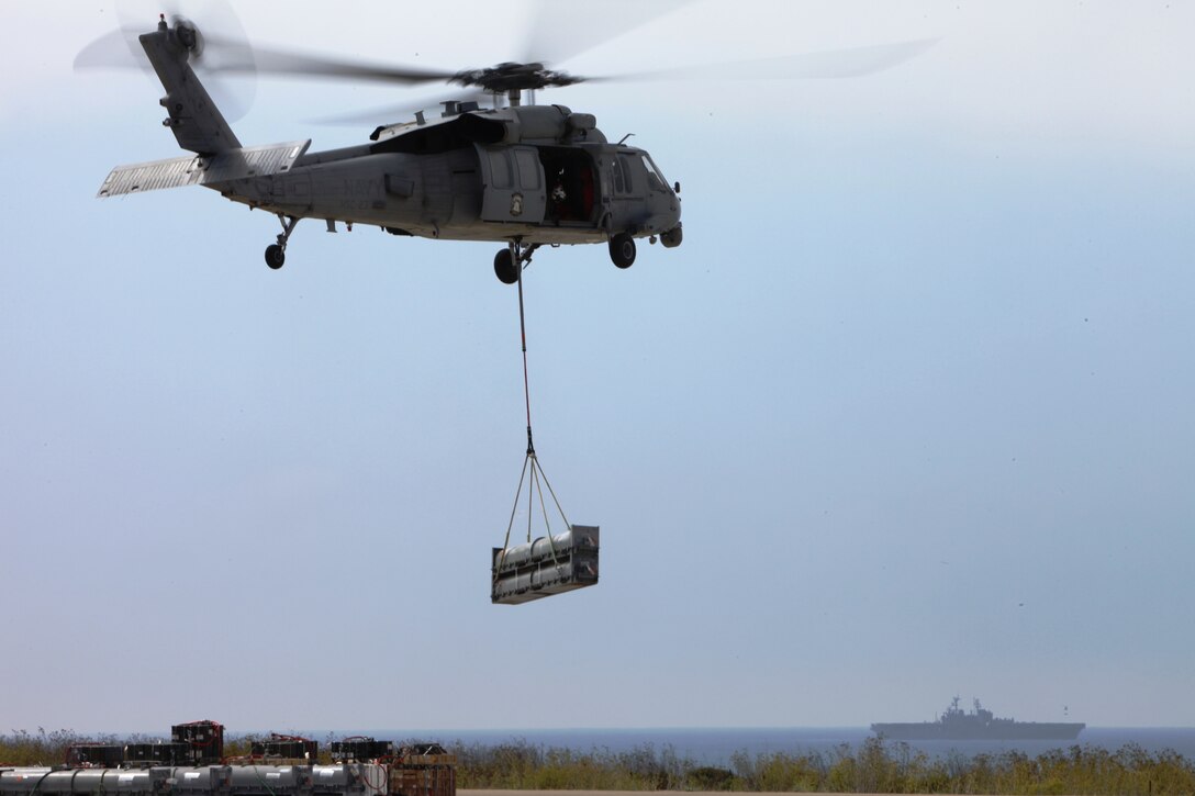 A UH-60 Black Hawk transports cargo to the USS Bonhomme Richard during a vertical replenishment operation at Camp Pendleton, Calif., Aug. 30. Marines from Landing Support Platoon, Transportation Support Detachment, Combat Logistics Battalion 15, Combat Logistics Regiment 17, 1st Marine Logistics Group, supported the exercise by rigging essential cargo.