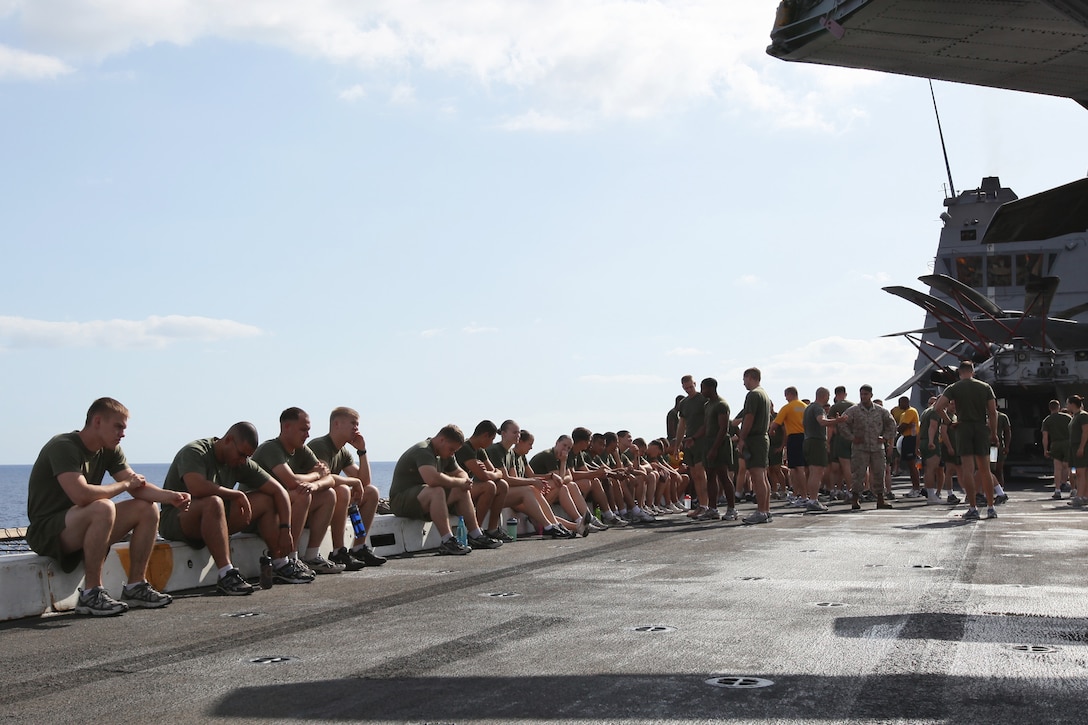 Sailors and Marines with Combat Logistics Battalion (CLB) 22, wait for physical training to begin aboard amphibious transport dock USS Mesa Verde (LPD 19), Aug. 30, 2011.  CLB-22 conducts biweekly battalion training to maintain physical fitness and to combat complacency during deployment. The Marines and sailors of the 22nd MEU are currently deployed with Amphibious Squadron 6 (PHIBRON 6) aboard the USS Bataan Amphibious Ready Group (BATARG) and will continue to train and improve the MEU’s ability to operate as a cohesive and effective Marine Air Ground Task Force.  The 22nd MEU is a multi-mission, capable force, comprised of an Aviation Combat Element, Marine Medium Tilt Rotor Squadron 263 (Reinforced)(VMM-263 (REIN)); a Logistics Combat Element, Combat Logistics Battalion 22(CLB 22); a Ground Combat Element, Battalion Landing Team, 2nd Battalion, 2nd Marine Regiment(BLT 2/2) and its Command Element.