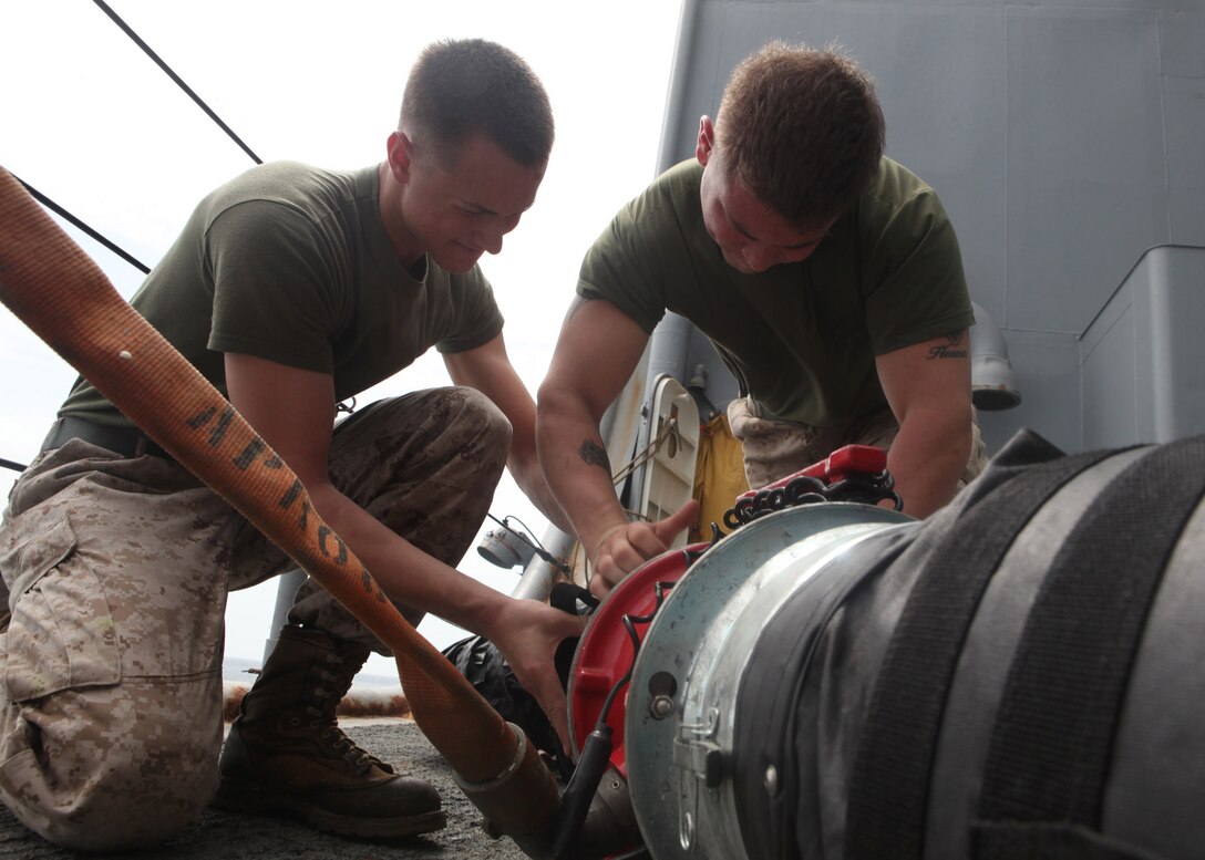 Pfc. William J. Kelly, left, a squad automatic weapon gunner with Echo Company, Battalion Landing Team, 2nd Battalion, 2nd Marine Regiment, 22nd Marine Expeditionary Unit (MEU), and Collegeville, Pa., native, and Lance Cpl. Wesley K. Earley, a rifleman with Echo Company, and Wheeling, W.Va., native race to put together ventilation tubes during damage control (DC) olympics aboard dock landing ship USS Whidbey Island (LSD 41). The DC olympics were part of a “steel beach picnic” recognizing the midpoint of the deployment, which featured games, events and food meant to boost the morale of Marines and Sailors currently deployed. The 22nd MEU is currently deployed as part of the Bataan Amphibious Ready Group (BATARG) as the U.S. Central Command theater reserve force, also providing support for maritime security operations and theater security cooperation efforts in the U.S. 5th Fleet area of responsibility.