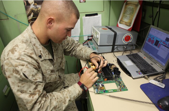 Cpl. Christopher Huber, a computer repair technician with Communications Electronic Maintenance platoon, 2nd Marine Logistics Group (Forward), solders a new component into place on a circuit card aboard Camp Leatherneck, Afghanistan, Aug. 31. As an alternative to buying new gear in some cases, the Marines of the Circuit Card Repair section fix electronic items down to the component level. The section has saved $105,000 over the last six months. (U.S. Marine Corps photo by Lance Cpl. Bruno J. Bego)