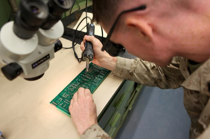 Cpl. Zachary Moats, a radio repairman with Communications Electronic Maintenance platoon, 2nd Marine Logistics Group (Forward) solders a new component into place on a circuit card aboard Camp Leatherneck, Afghanistan, Aug. 31. During the last six months, the section has saved quite a significant amount of money performing repairs like this - $105,000 to be exact, while only spending approximately $800 on repair parts. (U.S. Marine Corps photo by Lance Cpl. Bruno J. Bego)