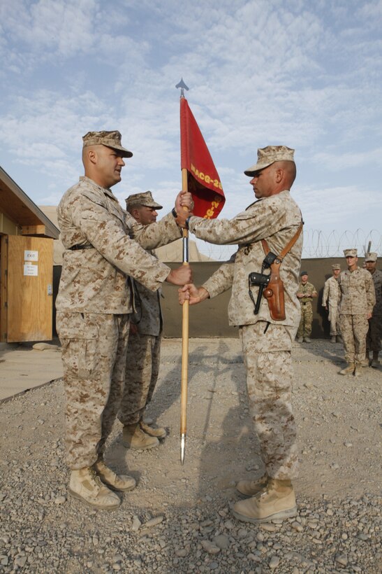 Sgt. Maj. Kenneth Lange, the outgoing sergeant major of Marine Air Control Group 28, delivers the group’s guidon to Lt. Col. Thomas Bajus, the outgoing commanding officer of MACG-28, during the group’s changeover at the halfway point of its yearlong deployment to Camp Leatherneck, Afghanistan, Aug. 31.