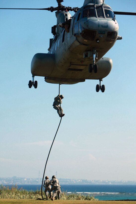 With the support of Marine Medium Helicopter Squadron 262, Marine Aircraft Group 36, 1st Marine Aircraft Wing, III Marine Expeditionary Force, soldiers from 1st Battalion, 1st Special Forces Group, conduct a fast-roping exercise from a CH-46 helicopter at the U.S. Army’s Torii Station Aug. 31.