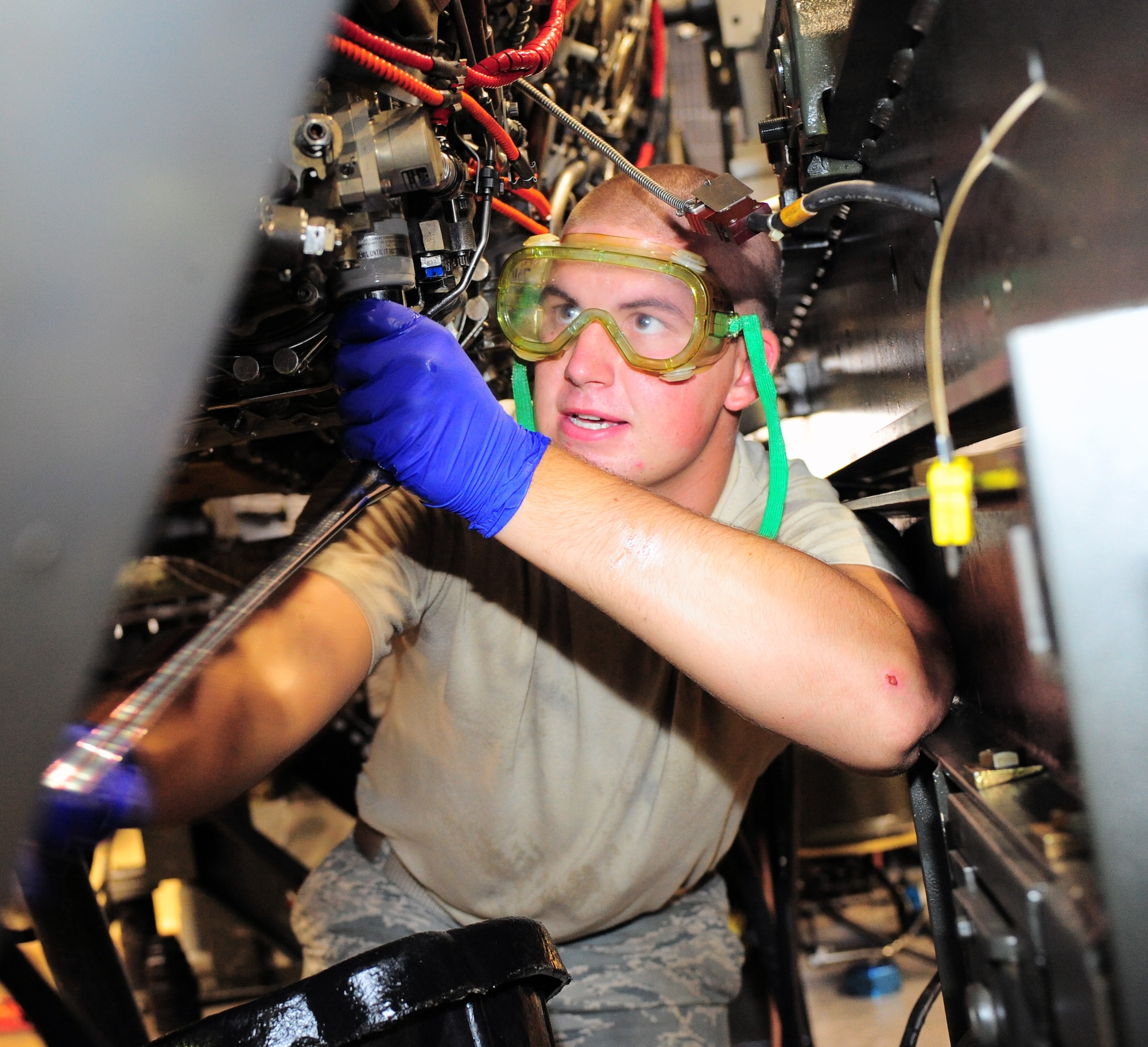 U.S. Air Force Airman 1st Class Kyle Wolf, 20th Compoment Maintenance Squadron engine maintainer, works on an F-16 engine at the engine test facility on Shaw Air Force Base, S.C., Aug. 26, 2011. The engine test facility is the final stop for jet engines before they are put back in aircraft. (U.S. Air Force photo/Airman 1st Class Daniel Phelps)(Released)