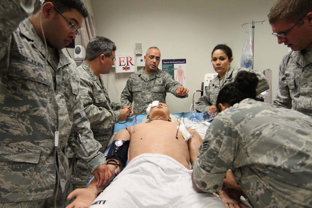 Chief Master Sgt. Adam Reading (center) directs reservists to check vitals on a simulated 
patient. The hi-tech patient has human-like features and can be programmed to exhibit a variety of medical conditions. All of the 932nd Airlift Wing medical reservists use the lastest training aids to enhance medical proficiency skills.  (U.S. Air Force photo/Tech. Sgt. Christopher)