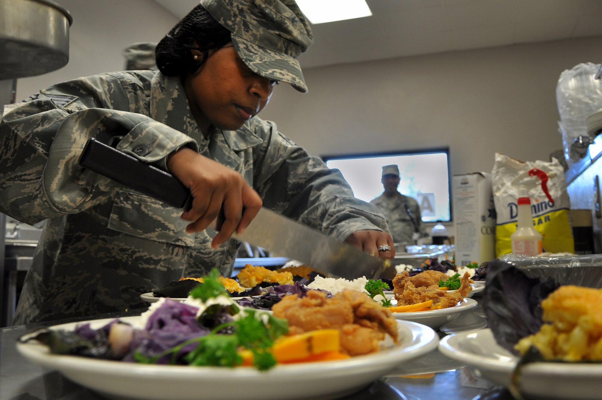 Tech. Sgt. April Dunham-Rhett, plates her dish during the Iron Chef competition at the Dining Facility, Shaw Air Force Base, S.C., Aug. 31, 2011. Dunham-Rhett was teamed with Chief Master Sgt. Lefford Fate, 20th Fighter Wing command chief. The duo made macaroni and cheese, fried chicken, cooked red cabbage and peach cobber. Dunham-Rhett is the 20th Fighter Wing NCOIC of Equal Opportunity. (U.S. Air Force photo/Senior Airman Alexandria Mosness) (Released)