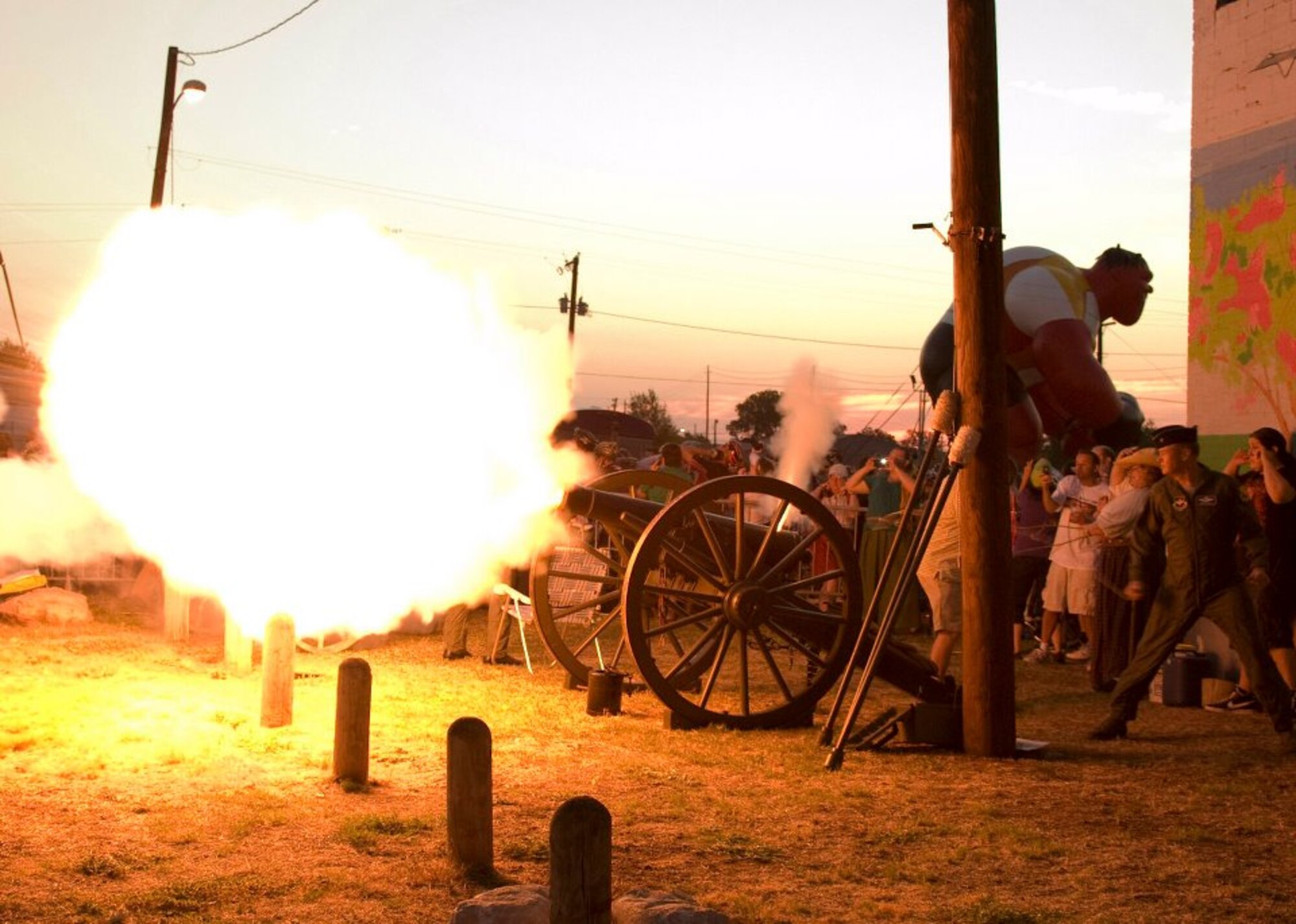 Brig. Gen. Darryl Burke and Col. Dieter Bareihs fire the cannon to begin the Hotter'N Hell Hundred International Bike Race in downtown Wichita Falls, Texas, Aug. 27. (U.S. Air Force photo/Danny Webb)