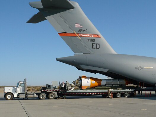 A jumbo drop test vehicle is loaded onto a C-17A for an airdrop Aug. 24. The JDTV was dropped over the U.S. Army Yuma Proving Ground to test the deceleration and recovery parachutes for the Ares I space program. The 85,000-pound JDTV set a record for heaviest single load ever extracted out of a C-17 during flight. (Courtesy photo/Chris Webber)