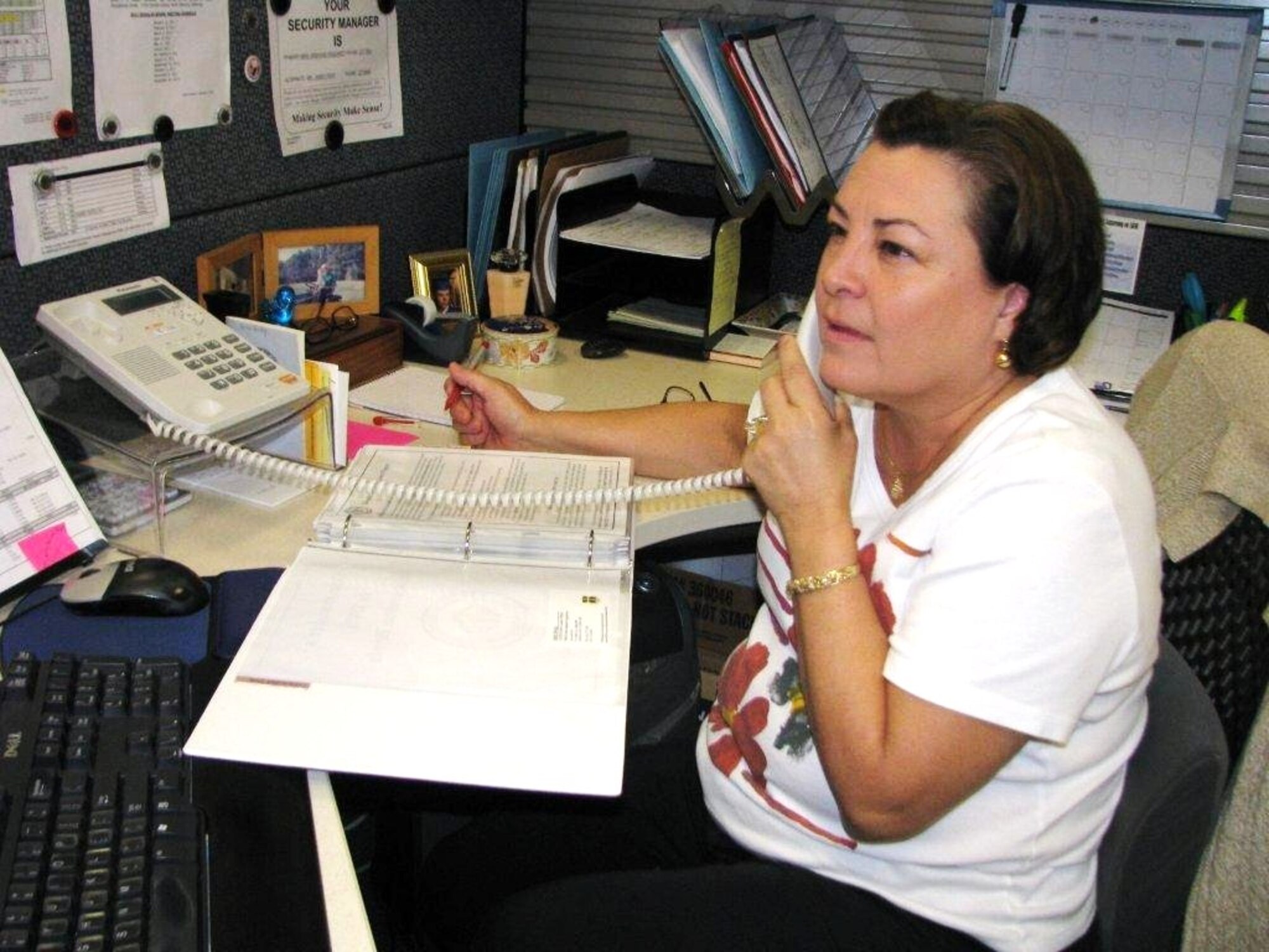 Beth Hodge, Edwards Air Force Base School Liaison Officer, works an issue in her office. Hodge is dedicated to helping parents and students transition in and out of Edwards schools. (Air Force photo by Diane Betzler)