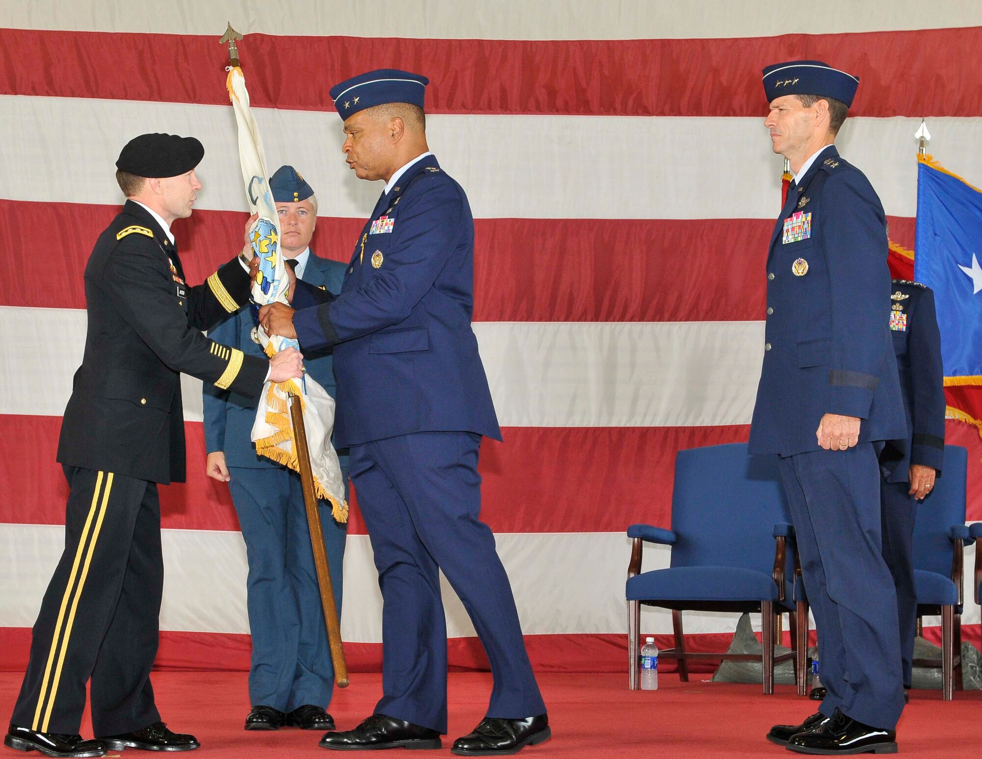 Maj. Gen. Garry C. Dean, center, passes the Continental U.S. North American Aerospace Defense Command Region to Gen. Charles H. Jacoby, NORAD commander, during the Continental U.S. North American Aerospace Defense Command Region-1st Air Force (Air Forces Northern) change of command ceremony at Tyndall Air Force Base, Fla., Aug. 31. Dean relinquished command of CONR to Lt. Gen. Sid Clarke, marking the first time a lieutenant general has ever held a command billet at Tyndall. (U.S. Air Force photo by Lisa Norman)