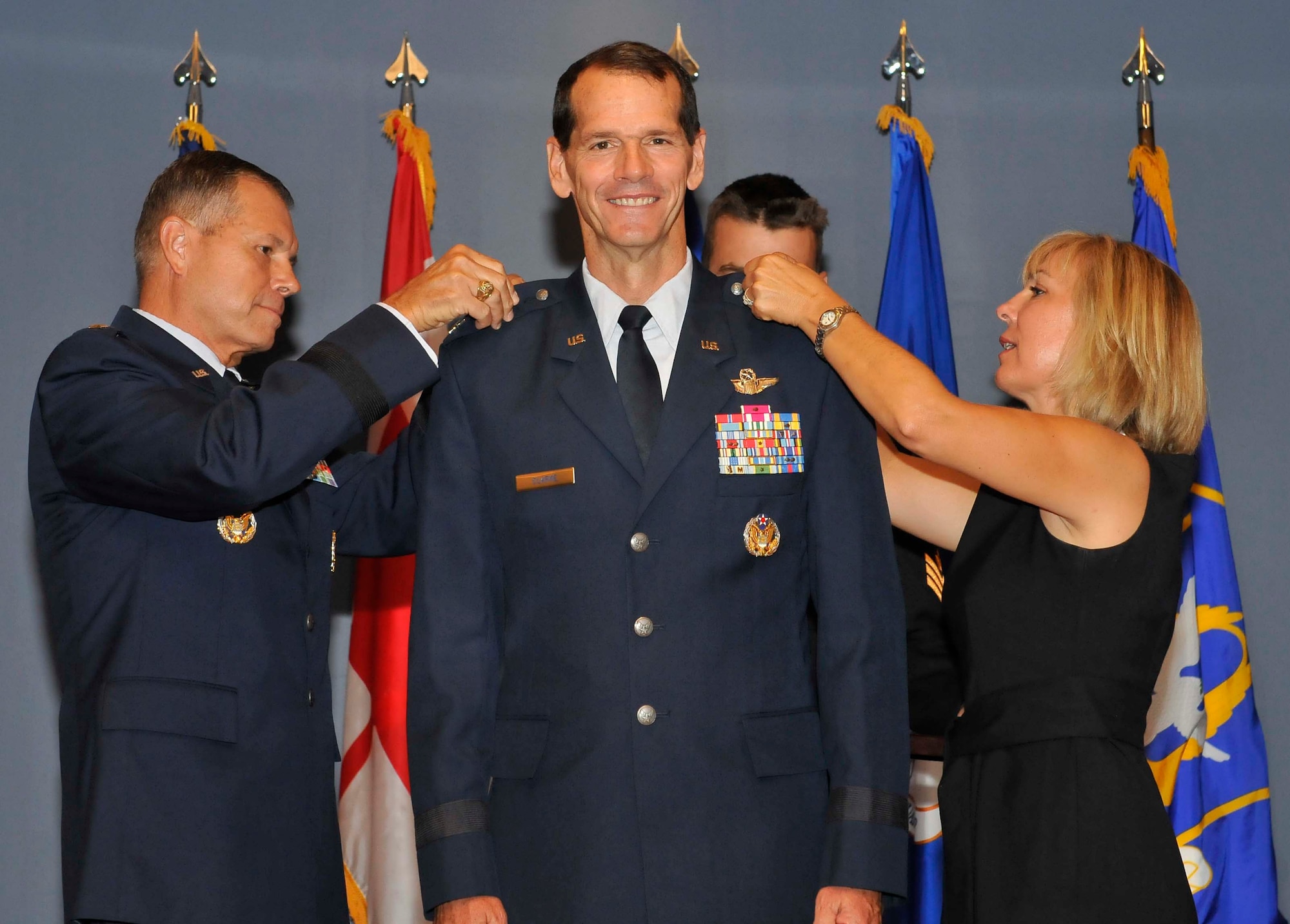 Gen. William M. Fraser, Air Combat Command commander, pins a third star Lt. Gen. Sid Clarke, the new Continental U.S. North American Aerospace Defense Command Region-1st Air Force (Air Forces Northern) with the help of Clarke’s wife Rebecca. Clarke received his third star Aug. 31 immediately before assuming command of CONR-1st AF (AFNORTH) and making history as the first lieutenant general to ever hold a command billet at Tyndall Air Force Base, Fla. (U.S. Air Force photo by Lisa Norman)