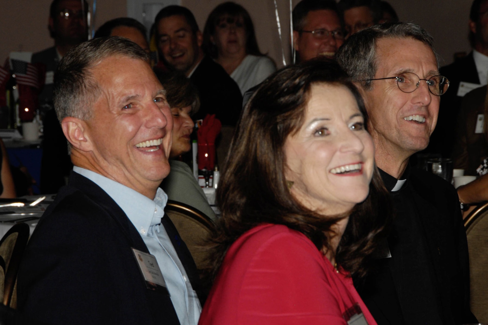 HANSCOM AIR FORCE BASE, Mass. - Lt. Gen. Ted Bowlds, Electronic Systems Center commander, his wife, Marcia, and his brother, Father Kent Bowlds, share a  laugh during General Bowlds' retirement dinner at the Minuteman Commons Aug. 30. (U.S. Air Force photo by Linda LaBonte Britt)