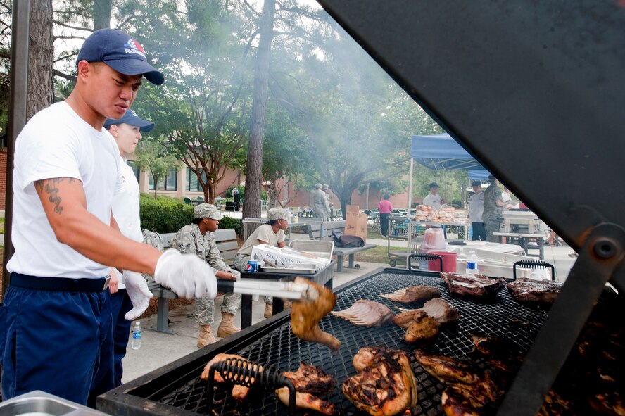 U.S. Air Force Senior Airman Johnny Liu, a food services specialist with the 23rd Force Support Squadron (FSS), mans the grill during a 23rd FSS block party on Moody Air Force Base, Ga., Aug. 30, 2011. The block party not only acted as the dinner service for base personnel but also allowed the squadron to showcase some of the programs it offers to Team Moody. (U.S. Air Force photo by Staff Sgt. Joshua J. Garcia/Released) 