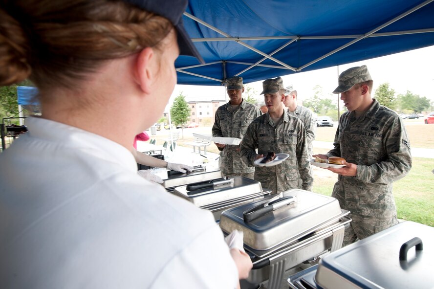 U.S. Air Force Staff Sgt. Ashley Cook, a food services specialist with the 23rd Force Support Squadron (FSS), prepares to serve members of Moody Air Force Base, Ga., during a 23rd FSS block party Aug. 30, 2011. The block party is one of two big events the squadron held to compete for the John L. Hennessy Award, a competition that honors the top Air Force foodservice programs. (U.S. Air Force photo by Staff Sgt. Joshua J. Garcia/Released)